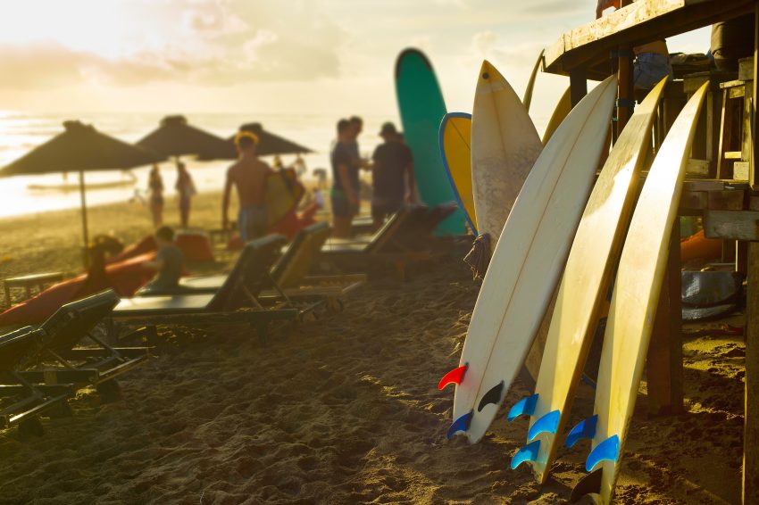 Surfboards for rent on Bali beach at sunset, Canguu