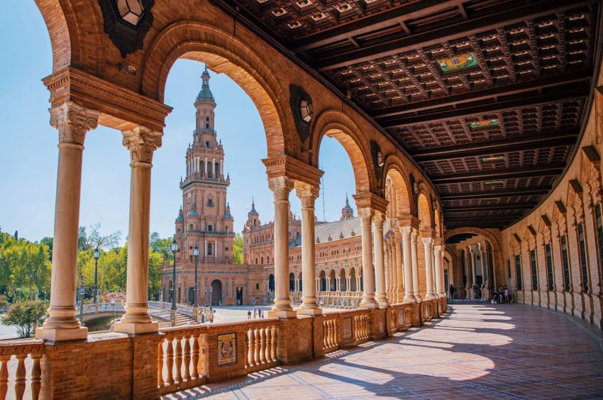 a large brick building with pillars Seville Spain