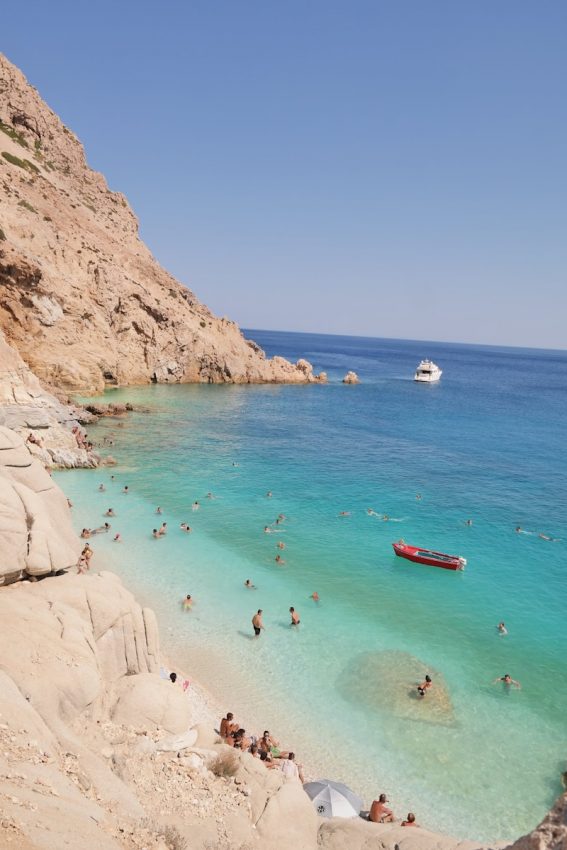 a group of people swimming in the ocean Ikaria Greece
