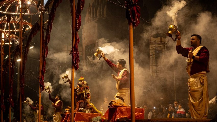 a group of men standing on top of a stage Varanasi India