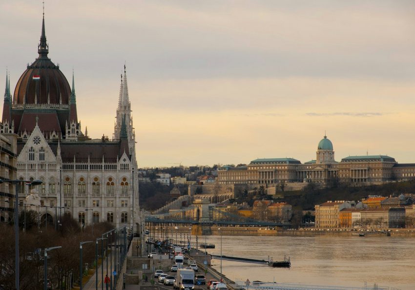 brown and white concrete building near body of water during daytime Budapest Hungary Danube