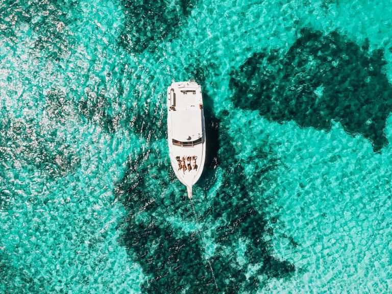 white yacht on body of water, Roatan