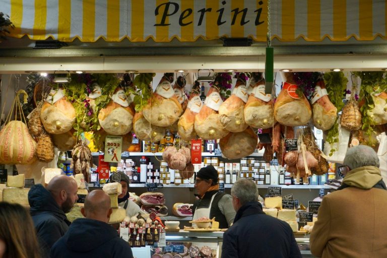 a group of people standing in front of a store, Florence, Italy