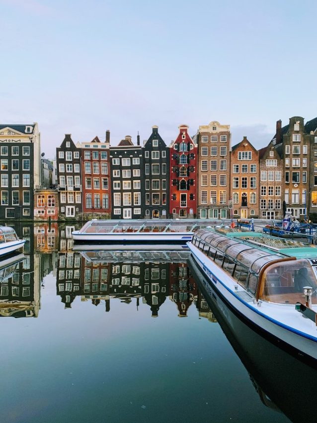 boat on water near buildings during daytime