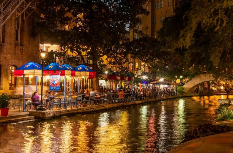 a river runs through a city at night